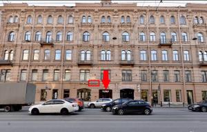 a large building with cars parked in a parking lot at Geleon in Saint Petersburg
