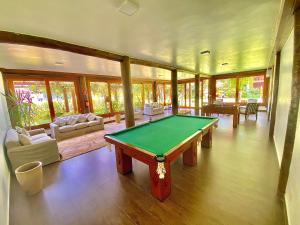 a living room with a pool table in it at Maresias flat mata azul in Maresias