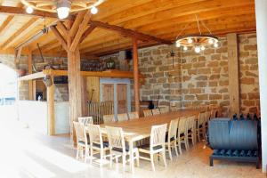 a dining room with a wooden table and chairs at Pension Prietzel in Dorf Wehlen