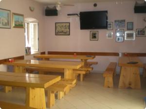 a room with wooden tables and a flat screen tv at Apartment in Susak with air conditioning, W-LAN (3865-6) in Susak