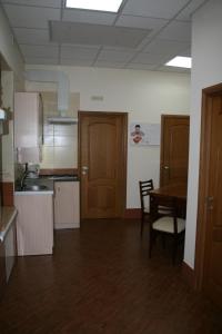 a kitchen with a table and a dining room at Bike Hostel Dnepr in Dnipro