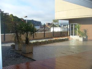 a building with potted plants in front of a building at 646 Hotel Balcarce in Balcarce