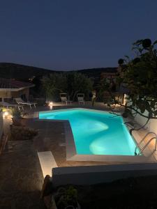 a swimming pool in a backyard at night at Sa Murta Bianca Guesthouse in Budoni