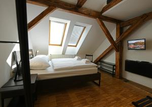 a bedroom with a bed in a attic at ATIK ROOMS in Ljubljana