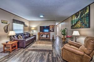 a living room with couches and a flat screen tv at Boating Mecca Near Dale Hollow Lake and Golf! in Frogue