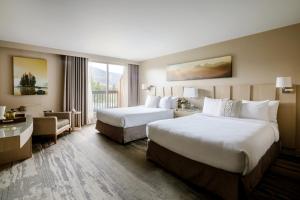 a hotel room with two beds and a window at Forest Park Hotel in Jasper