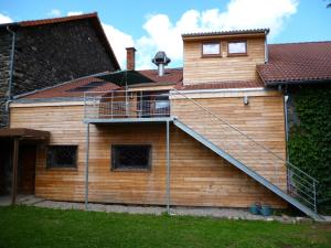 a house with a staircase on the side of it at Le Gîte de L'Ours in Saint-Ours