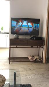 a person laying on the floor in front of a television at הבית של גוטה מחוף מציצים in Tel Aviv