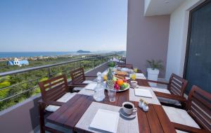 a table with a bowl of fruit on a balcony at Villa Elisabeth View in Platanias
