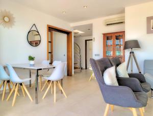 a living room with a table and chairs at Cofradia Penthouse in Alcudia