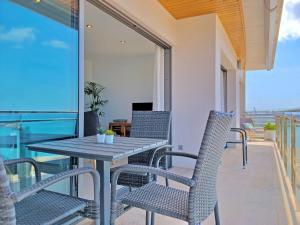 a table and chairs on the balcony of a house at Cofradia Penthouse in Alcudia