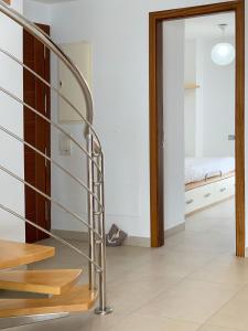 a glass staircase in a room with a bedroom at Cofradia Penthouse in Alcudia