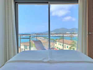 a bedroom with a bed and a view of the ocean at Cofradia Penthouse in Alcudia