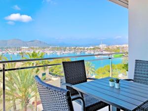 a table and chairs on a balcony with a view of the water at Cofradia Penthouse in Alcudia