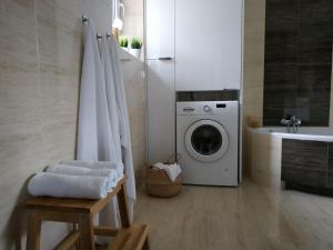 a bathroom with a washing machine and a sink at Pauza-Limanowa in Limanowa