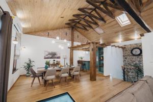a dining room and living room with a table and chairs at Elia City House in Kavála