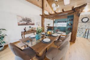 a dining room with a wooden table and chairs at Elia City House in Kavála