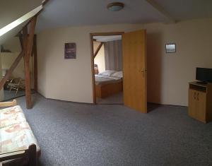 a bedroom with a bunk bed and a door to a room at Hotel Kralicek in Turnov