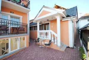 a balcony of a house with a table and chairs at Villa Ana in Gornja Trepča