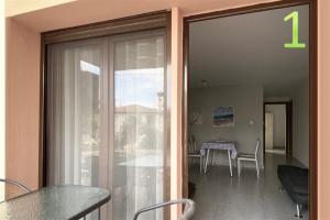 a sliding glass door to a dining room with a table at Afitos Guest House in Afitos