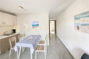 a kitchen and dining room with a table and chairs at Afitos Guest House in Afitos