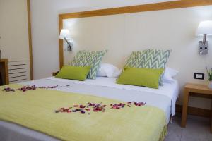 a bedroom with two beds with flowers on the bed at Best Western Hotel Martello in Lampedusa