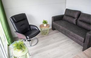 a living room with a couch and a chair at Awesome Ship In Biddinghuizen in Biddinghuizen