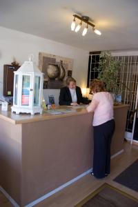 two women standing at a counter in a room at Hotel Bella Vista in Konstanz