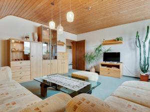 a living room with a couch and a table at Apartment with balcony in the Black Forest in Kappel