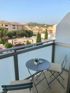 a table and two chairs on a balcony at Samsara Beach in Port d'Alcudia