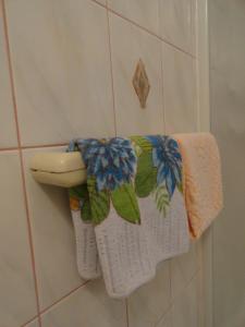 a towel rack with towels on a toilet in a bathroom at Apartments & Rooms Karmela in Banjol