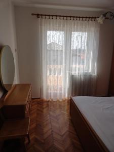 1 dormitorio con 1 cama, vestidor y ventana en Apartments & Rooms Karmela, en Banjol