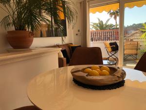 a table with a bowl of oranges on it at Azamara old town Residence in Hvar