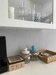 a shelf with dishes and a tea box on a counter at SeaBreeze Vernazza in Vernazza