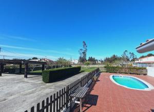 un patio avec un banc et une piscine dans l'établissement A Casa do Lareiro, à Sanxenxo