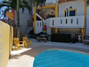 a house with a swimming pool in front of a house at MonteMar Hotel y Bungalows in Rincon de Guayabitos