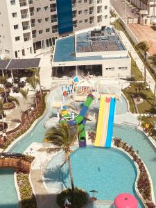 a pool with a water slide in a resort at Salinas Exclusive Resort in Salinópolis