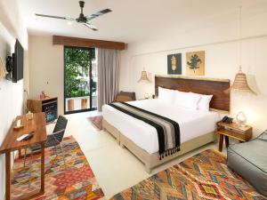 a bedroom with a large bed and a large window at Naala Tulum in Tulum