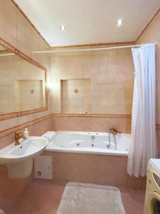 a bathroom with a bath tub and a sink at Historical Centre Apartments in Lviv +92 photos