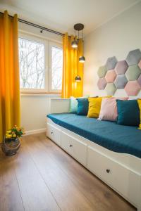 a bedroom with a large bed with colorful pillows at Song`s Apartment in Sopot