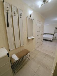 a bathroom with white cabinets and a bed in a room at Historical Centre Apartments in Lviv