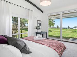a bedroom with a bed and a large window at Red Hill Ridge in Dromana