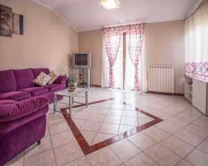 a living room with a purple couch and a tv at Apartment in Vrbnik/Insel Krk 14527 in Vrbnik