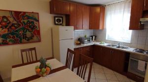 a kitchen with a table with a bowl of fruit on it at Apartment in Malinska/Insel Krk 14682 in Porat
