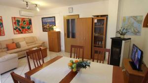 a kitchen and living room with a table and chairs at Apartment in Malinska/Insel Krk 14682 in Porat