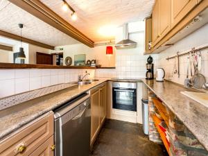 a kitchen with a sink and a dishwasher at Magnificent Holiday Home in Sint Martens Voeren with Garden in Berg