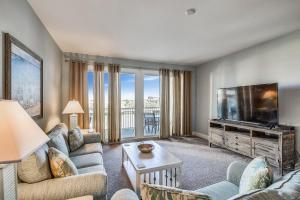 un soggiorno con divano e TV a schermo piatto di Laketown Wharf Resort #226 by Book That Condo a Panama City Beach