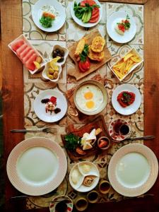 a table full of plates of food on a table at TORRHEBİA DAĞ EVİ in Odemis