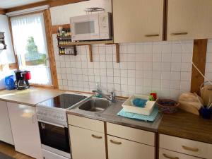 a kitchen with a sink and a microwave at Holiday home in Gustow - Insel Rügen 3077 in Gustow +7 photos