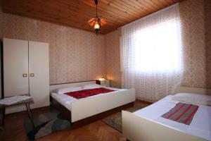 a bedroom with two beds and a window at Apartment in Silo/Insel Krk 14539 in Šilo